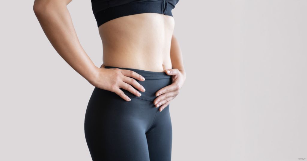 Woman holding their stomach. (Model)