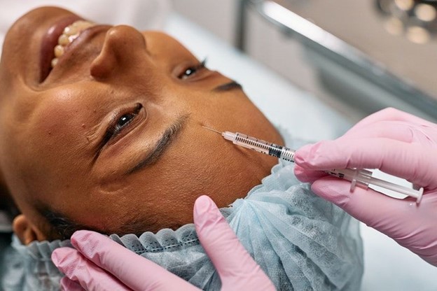 Woman receiving a dermal filler injection (models)