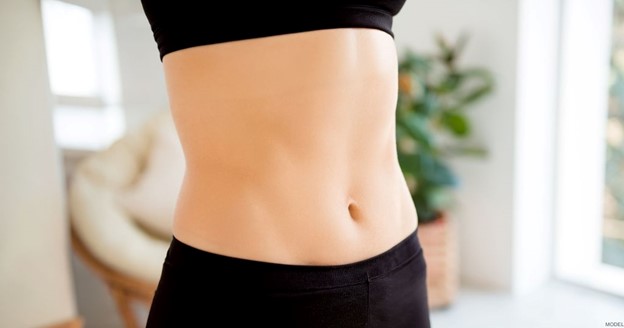 Woman’s stomach after a mini tummy tuck (model)