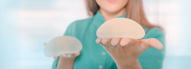 Woman comparing breast procedure options (model)